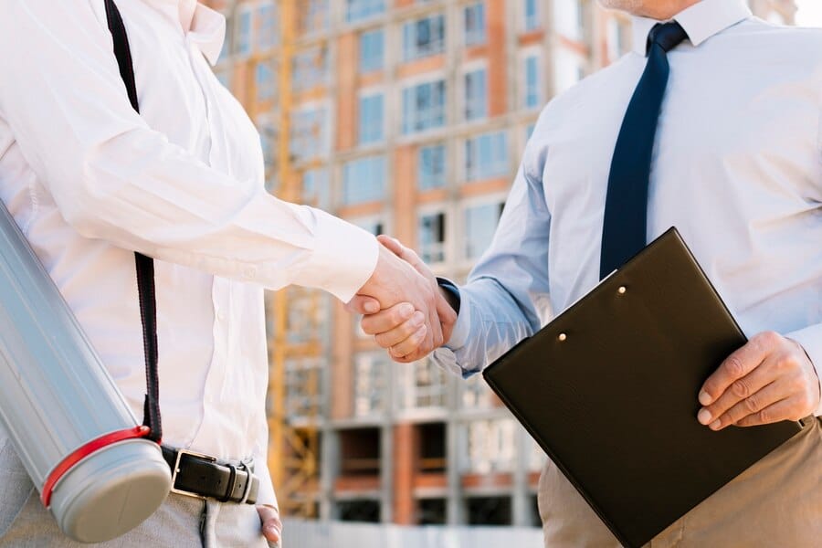 Businessmen shaking hands outdoors