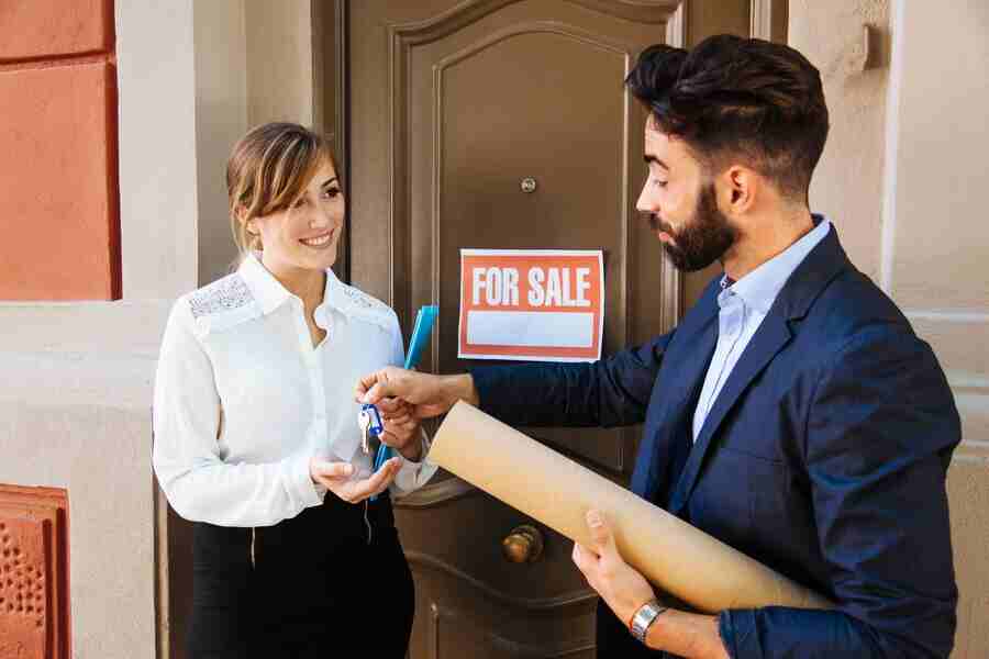 Realtor handing keys to buyer.