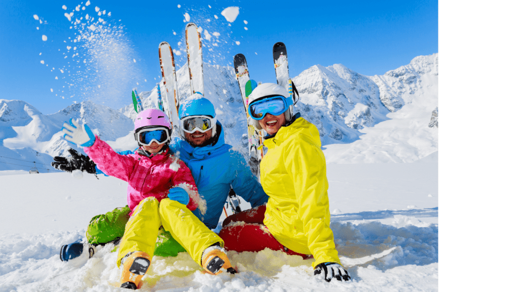 Family enjoying a ski vacation with colorful winter gear in a snowy mountain setting.