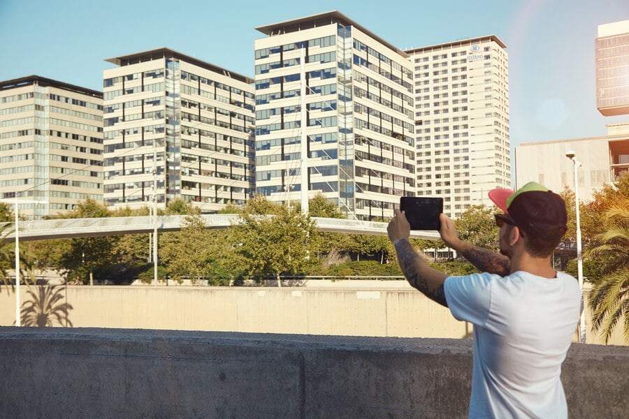 Man photographing urban rentals